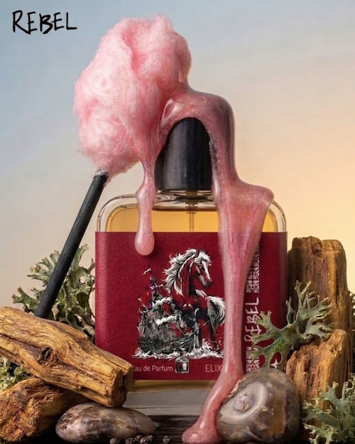 Elixir bottle with pink cotton candy-like substance dripping from it, set against a natural background.